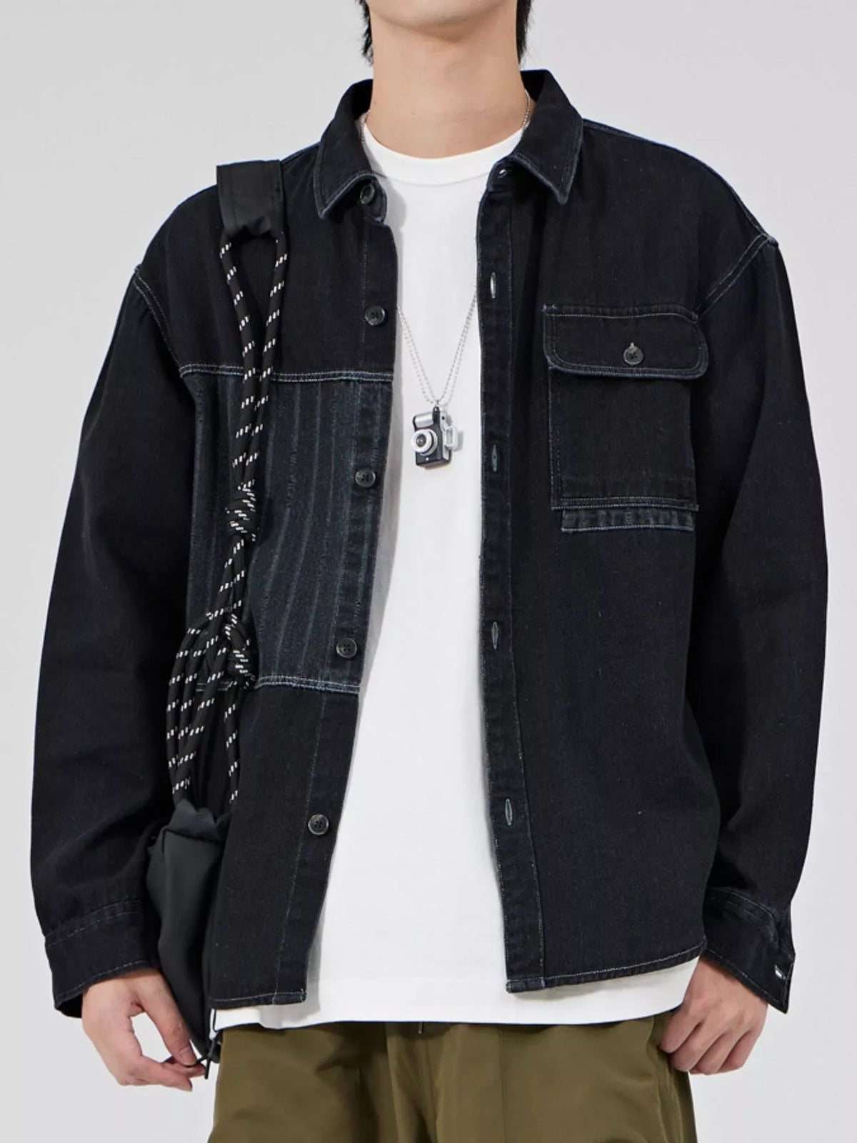 Black men's button-up denim shirt, front view with styling accessories