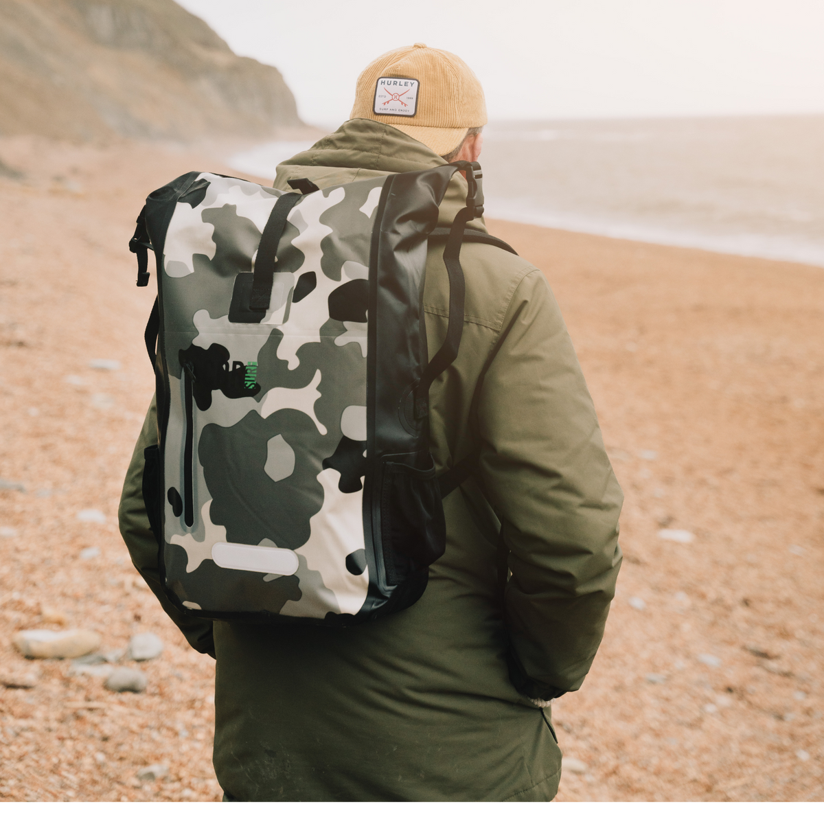 Camouflage backpack worn outdoors; clothing and accessories not included.