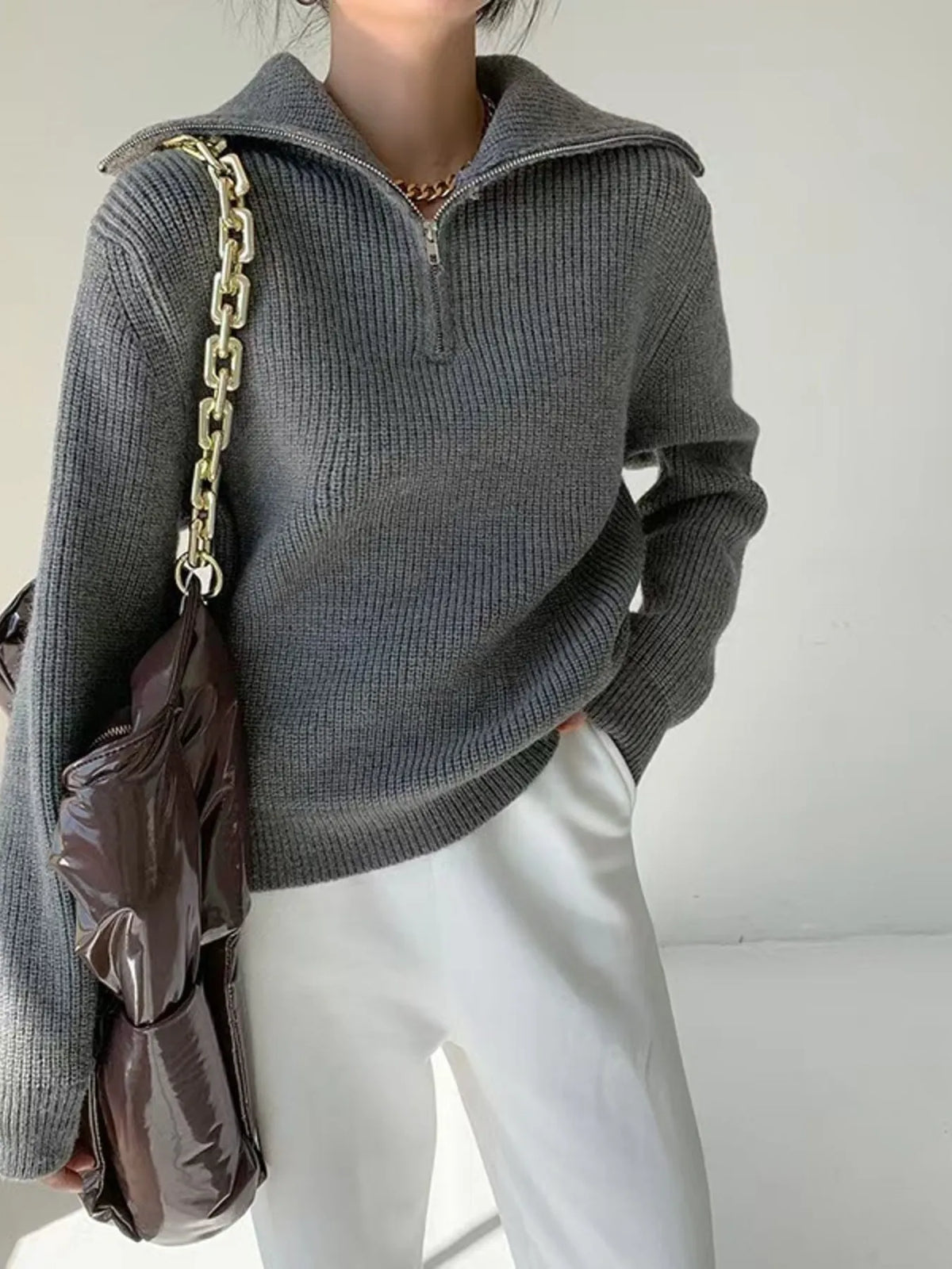 Half-zip long-sleeve ribbed sweater with a high collar.