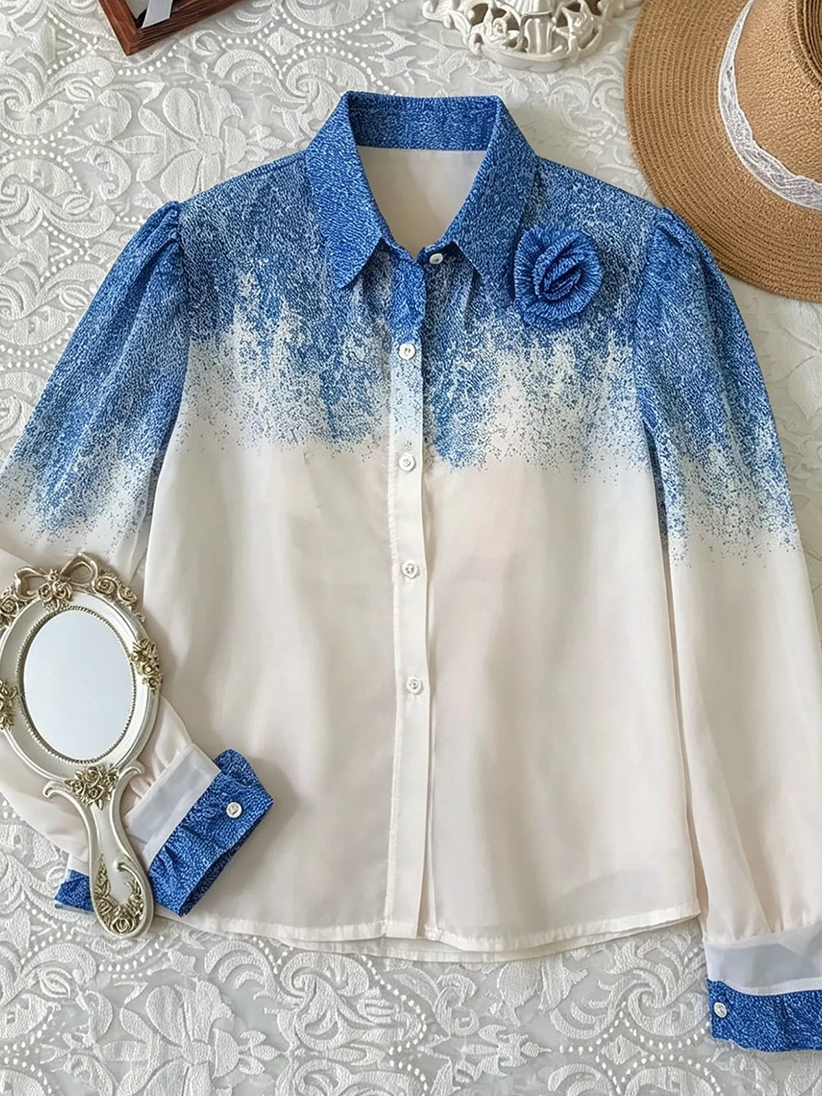 Blue-to-white gradient button-up shirt laid flat, front view