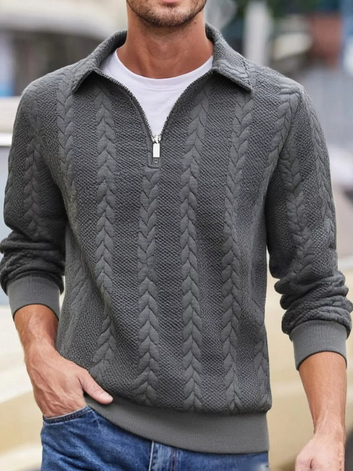 Men's charcoal-gray cable-textured quarter-zip pullover with pointed collar and ribbed cuffs and hem, shown on a model.