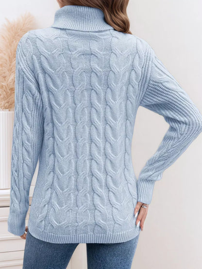 Cable-knit turtleneck sweater with long sleeves.