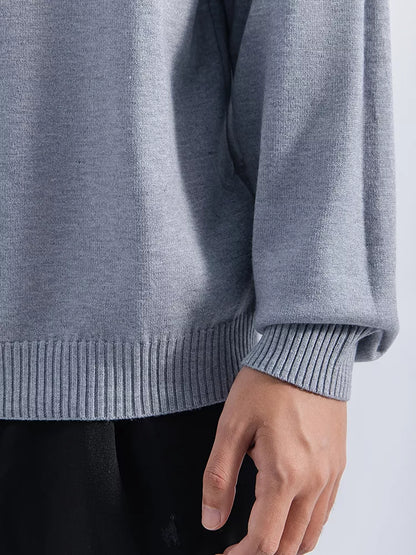 Men's Gray minimalist mock-neck sweater, cuff and hem ribbing detail view. Trousers are styling items and are not included.
