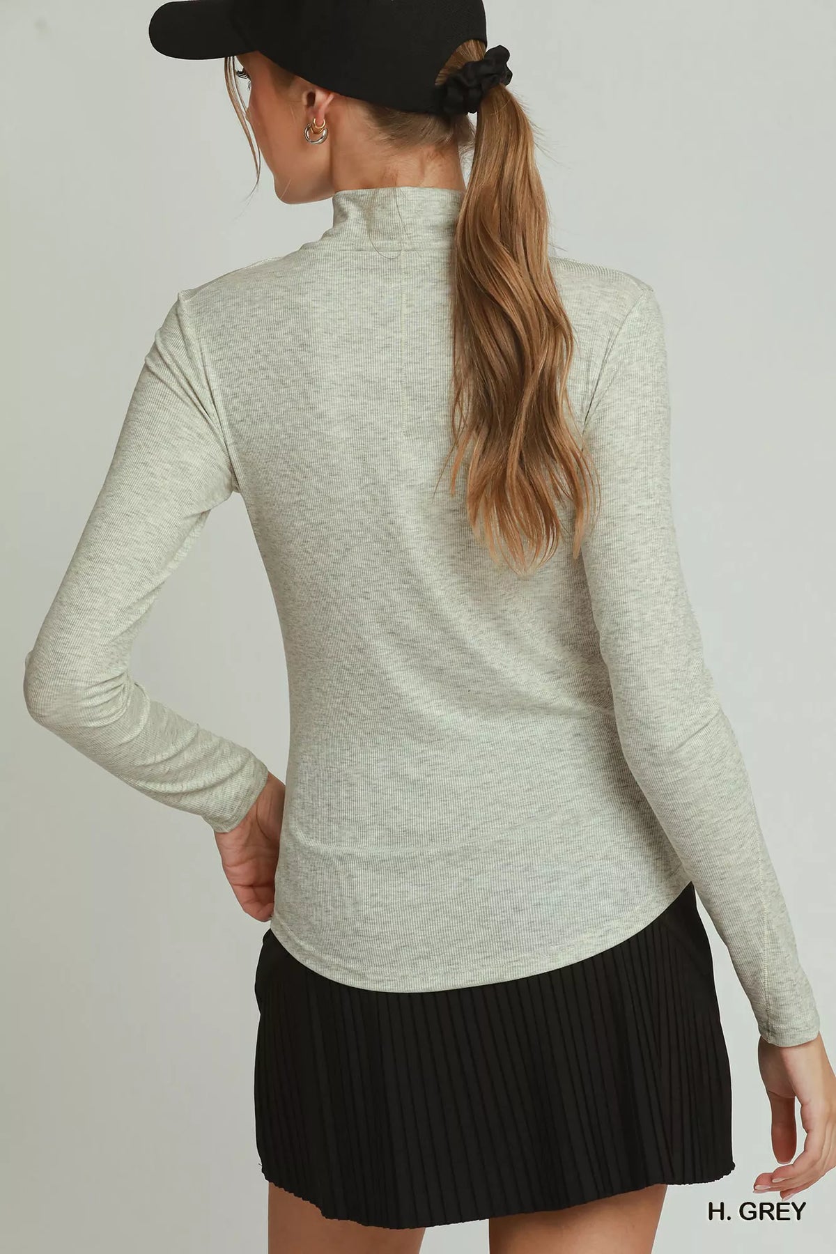 Back view of the heather-gray long-sleeve mock-neck top on a model. Top only.