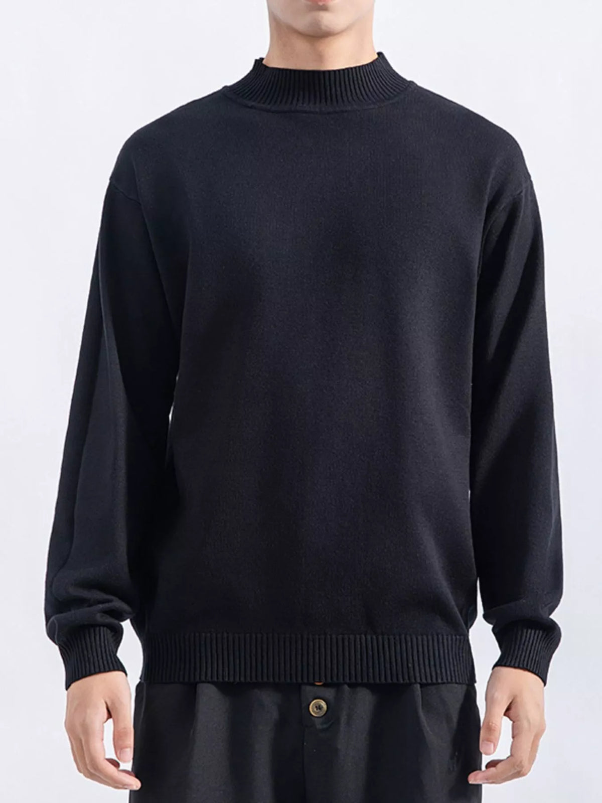 Men's Black minimalist mock-neck sweater, front view. Trousers are styling items and are not included.