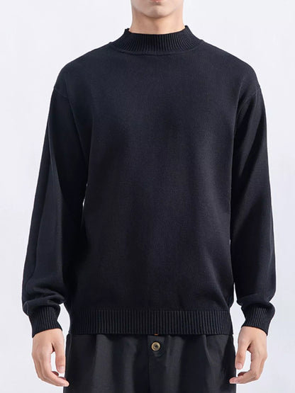 Men's Black minimalist mock-neck sweater, front view. Trousers are styling items and are not included.