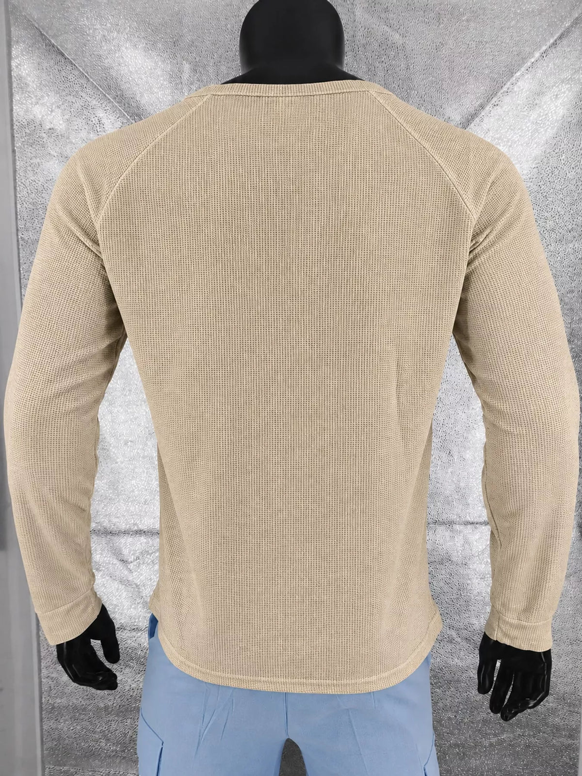 Dark khaki men’s waffle-knit Henley on a mannequin, back view.