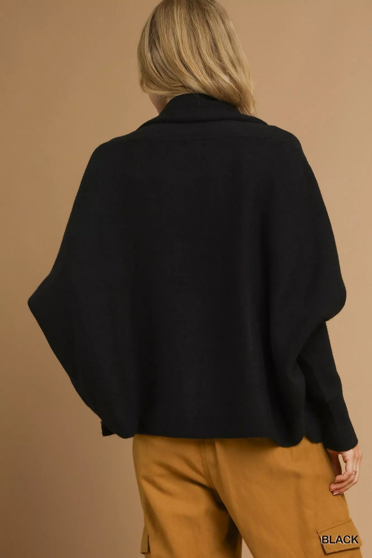 Back view of the black Umgee cardigan; styled trousers are not included.