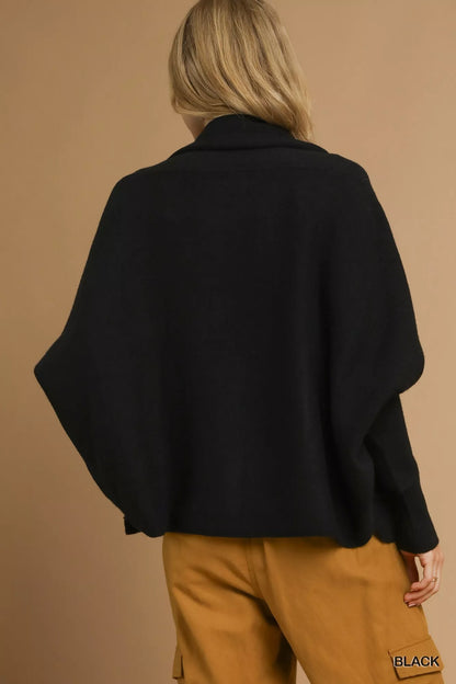 Back view of the black Umgee cardigan; styled trousers are not included.