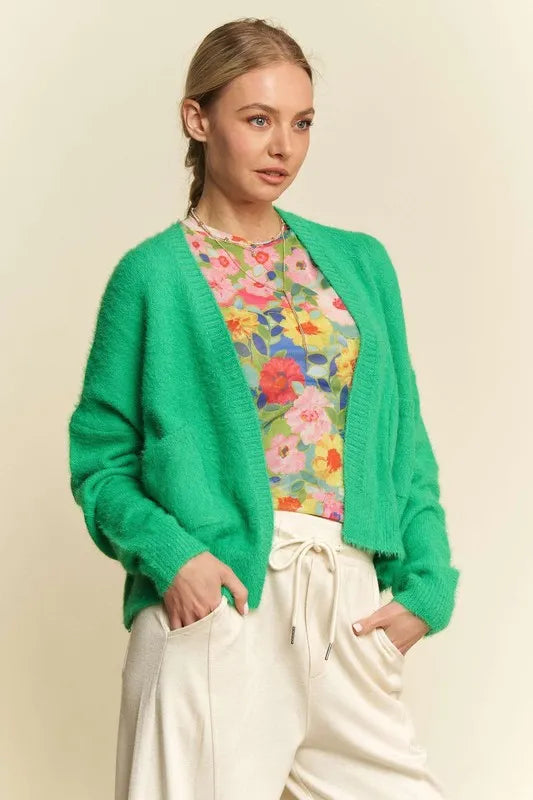 Green cardigan worn open, front view.