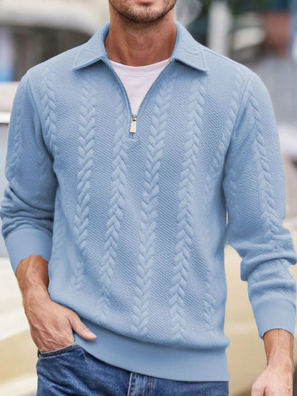 Men's light-blue cable-textured quarter-zip pullover with pointed collar and ribbed cuffs and hem, shown on a model.