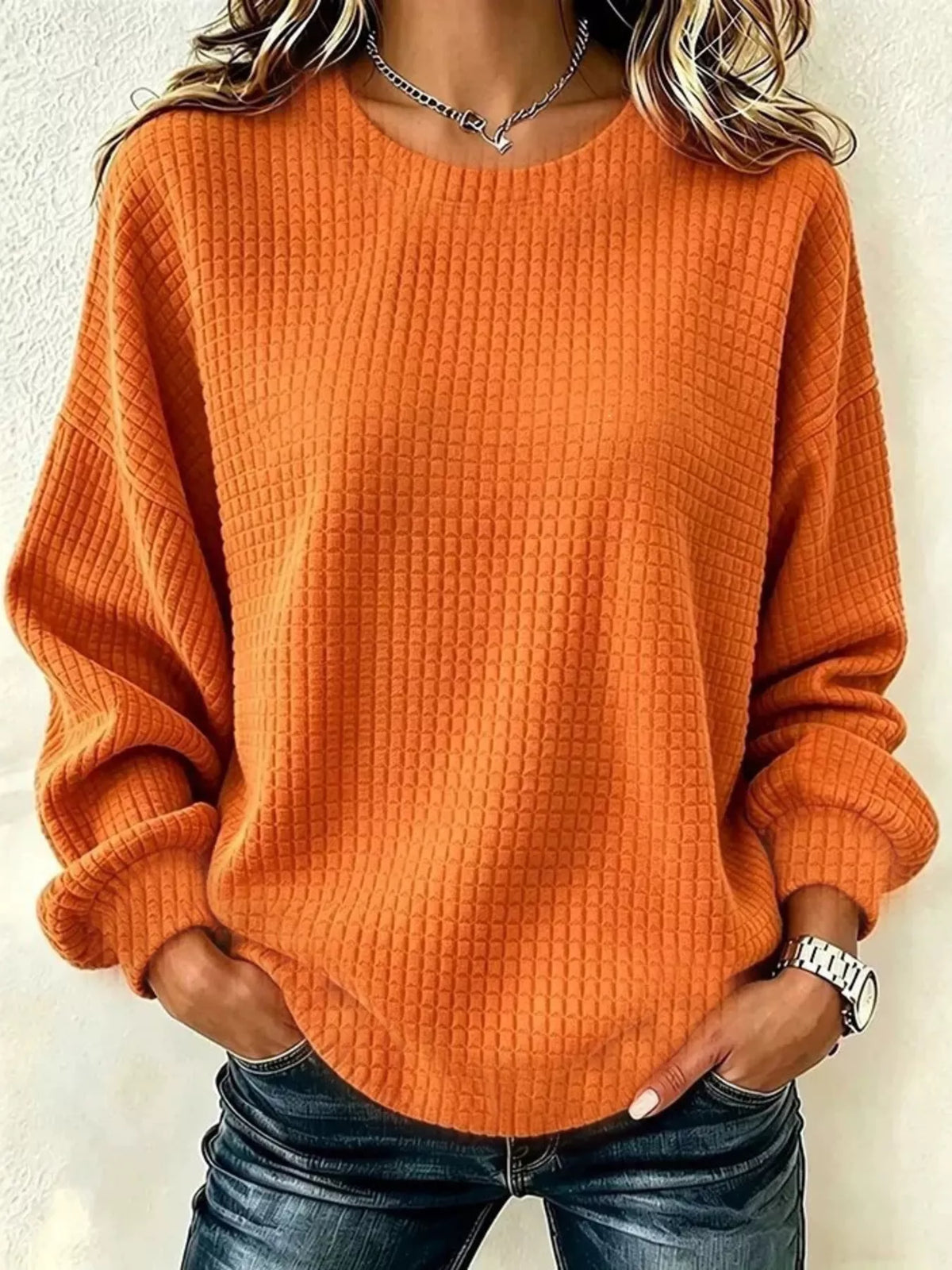 Front view of an Orange long-sleeve crew-neck waffle-knit sweatshirt. One top only.