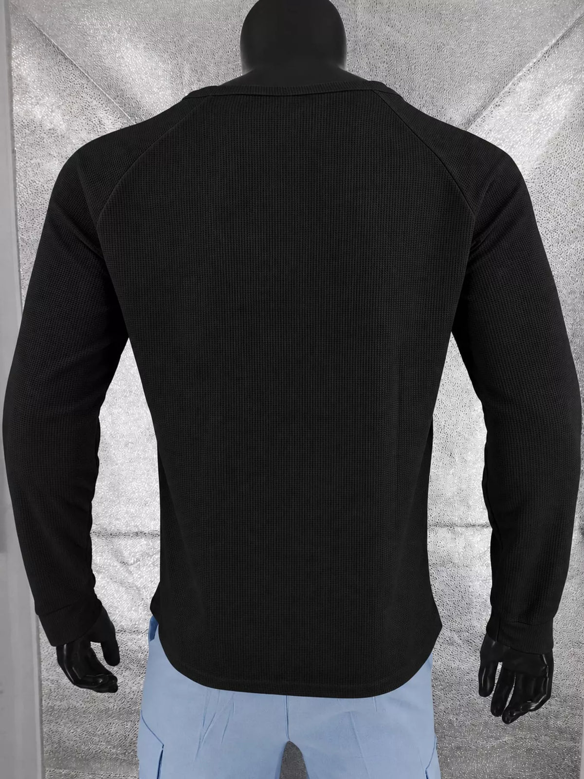 Black men’s waffle-knit Henley on a mannequin, back view.