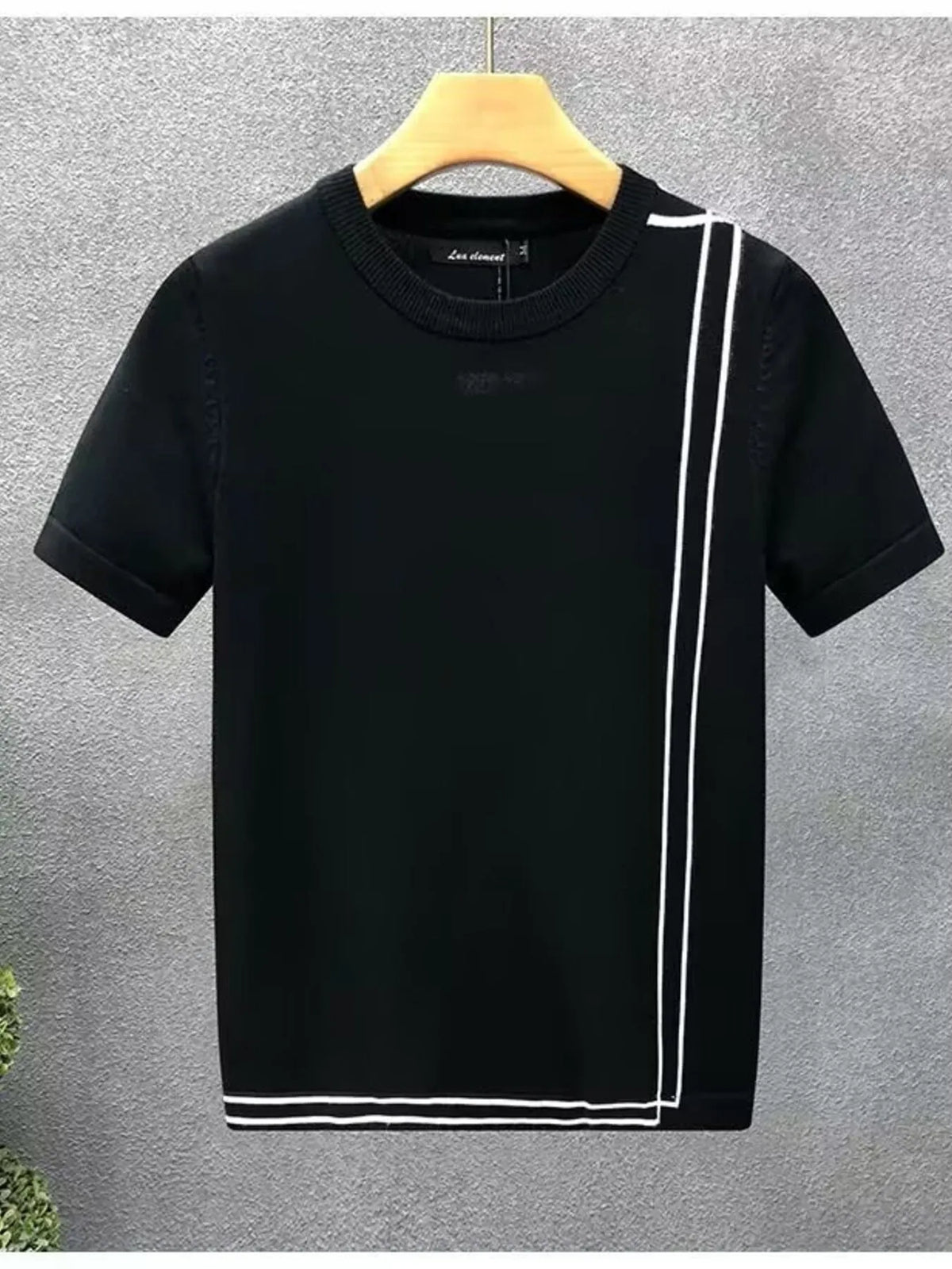 Black contrast-trim short-sleeve crewneck T-shirt on a hanger, front view.