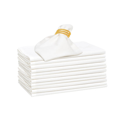 Stack of 12 white flour-sack cotton napkins with one folded napkin on top