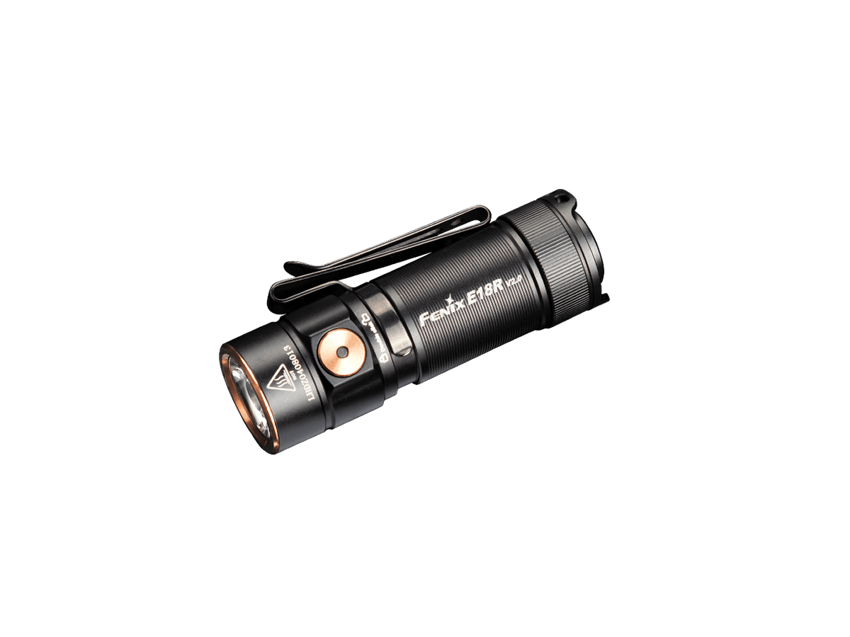 Black Fenix E18R V2 rechargeable flashlight on a green background