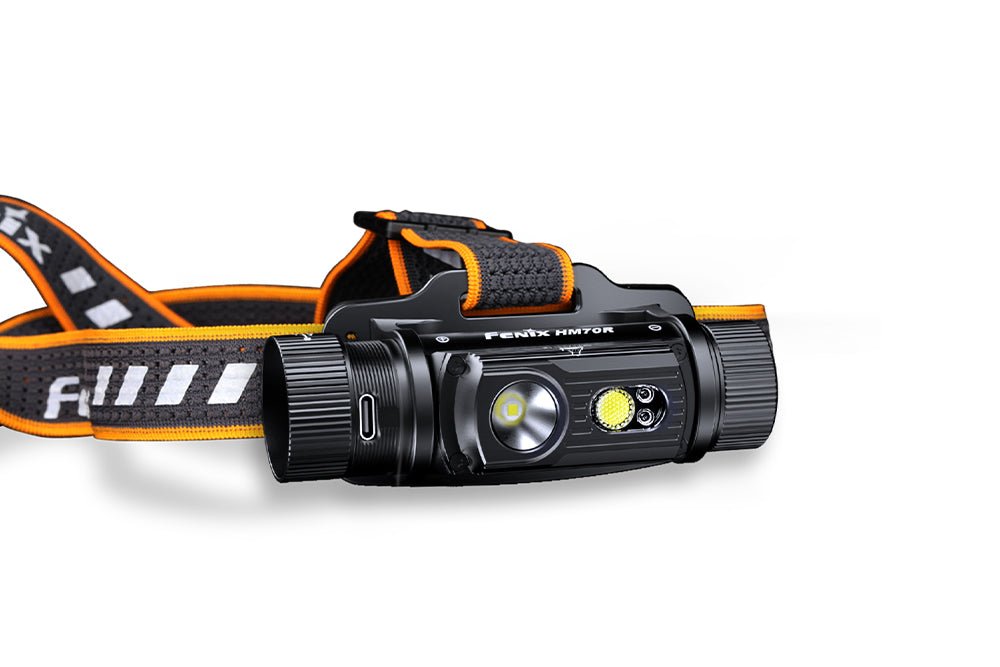 Side view of the Fenix HM70R headlamp and black-and-orange headband on white