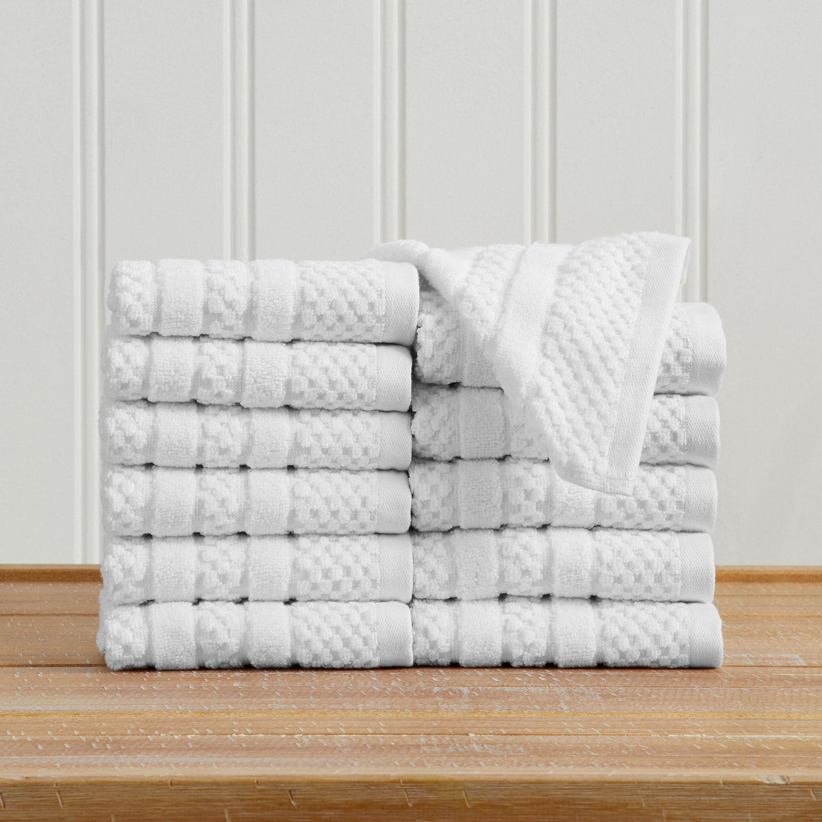 White Giuliana Collection checkered jacquard washcloths folded and stacked.