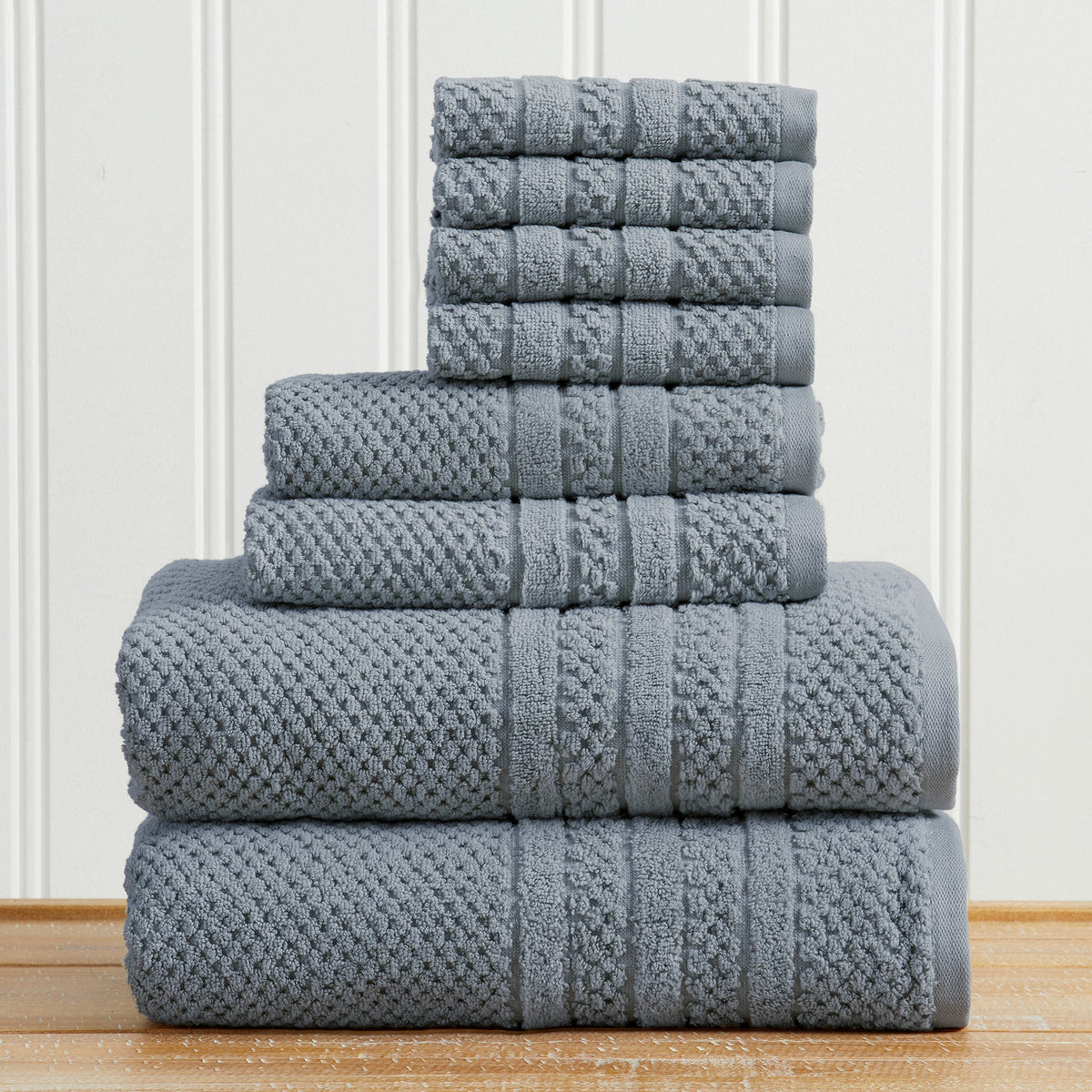 Blue Giuliana Collection checkered jacquard towel set folded in a stack.
