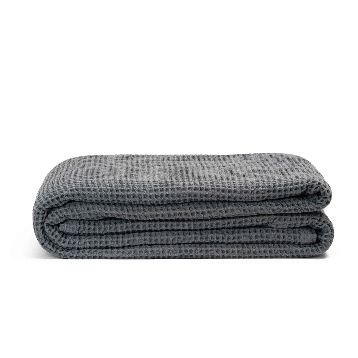 Gray cotton waffle weave throw folded on a white background
