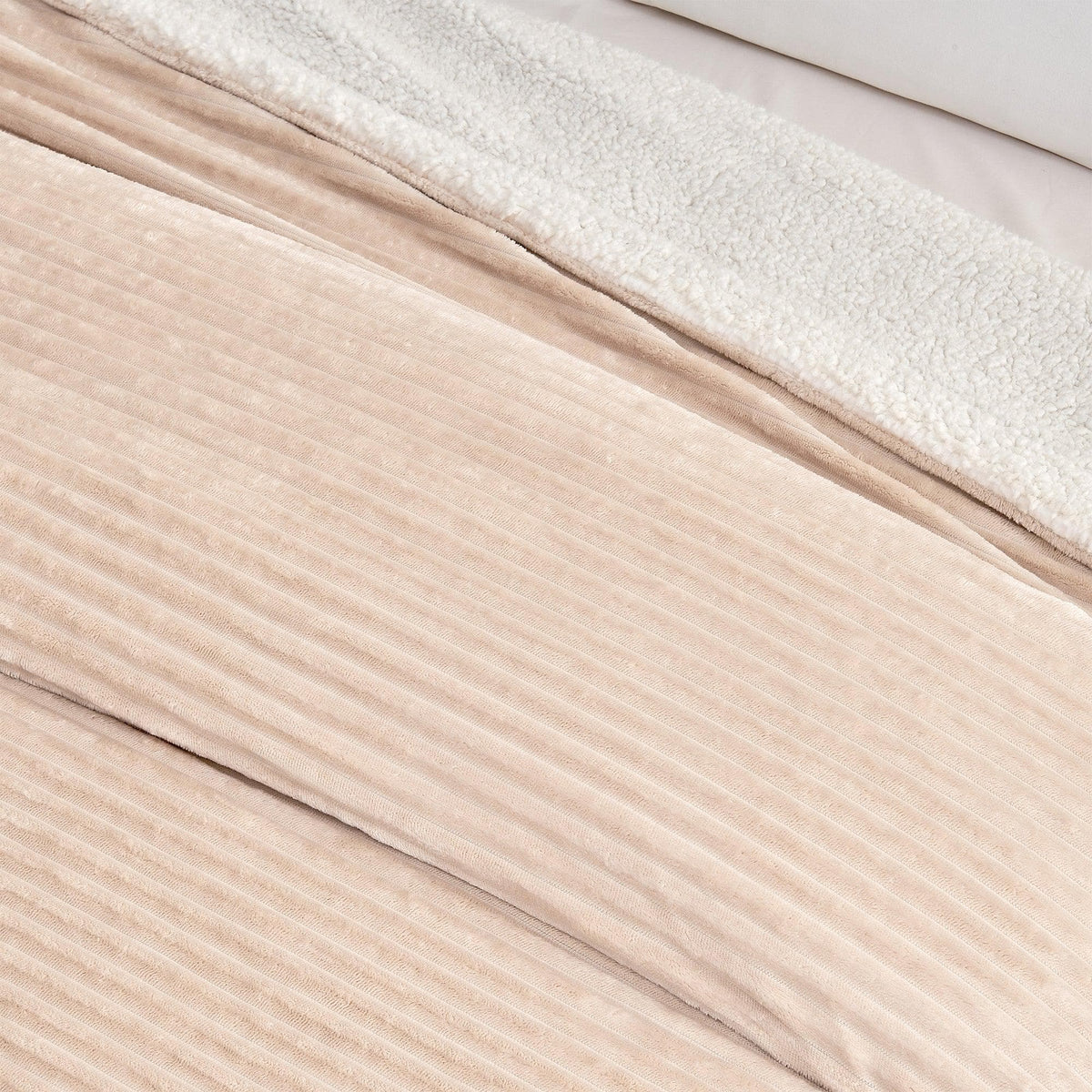 Close-up of the cappuccino ribbed face and pale sherpa reverse of the blanket.