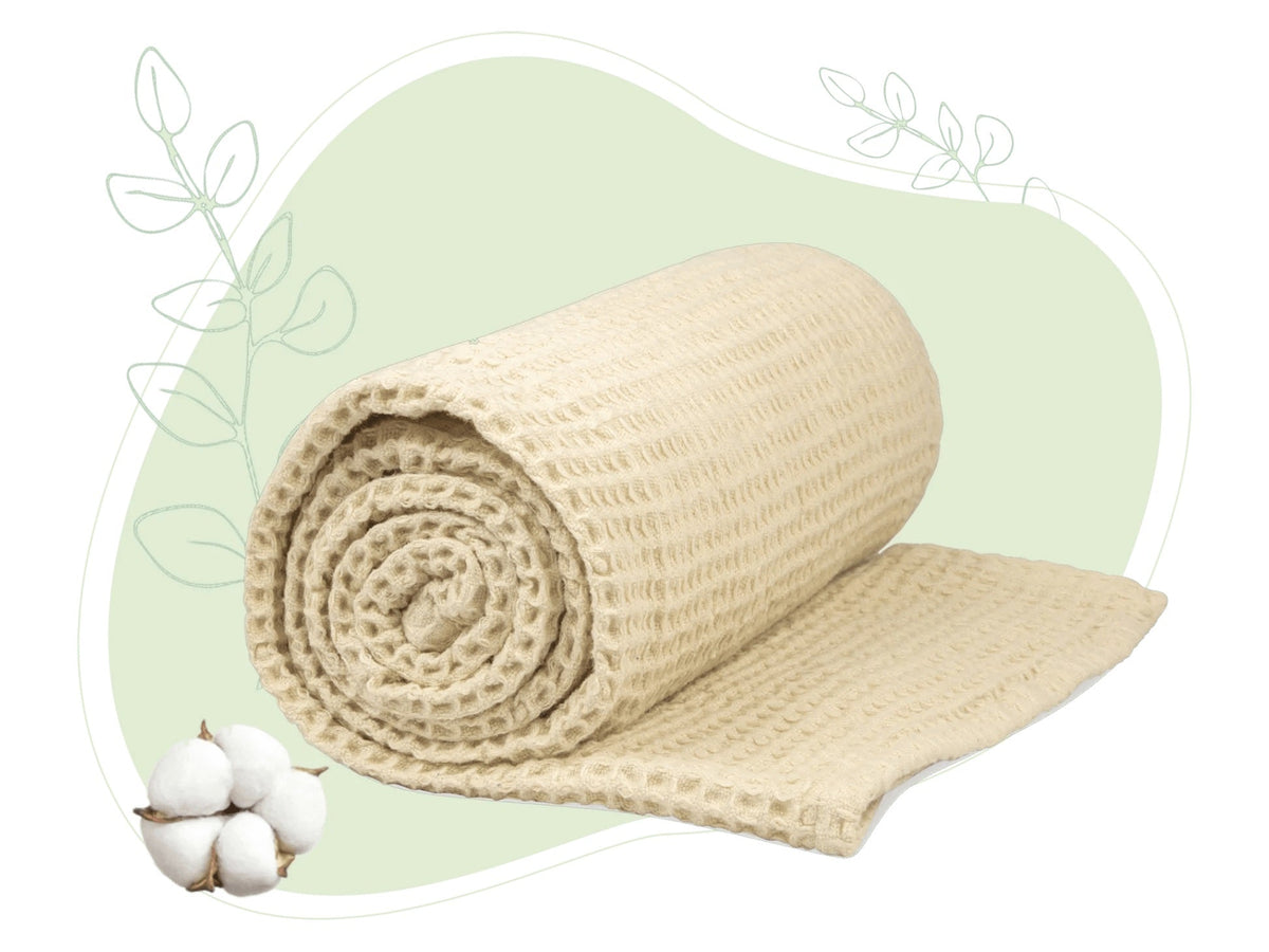 Ivory cotton waffle weave throw rolled and partly unrolled