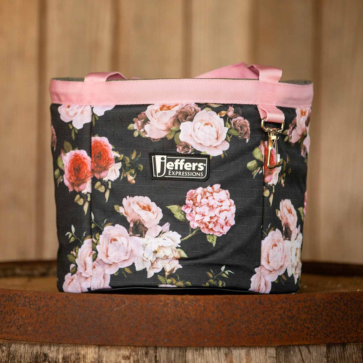 Rose Garden floral grooming tote shown on a wooden shelf, with pink handles and trim.