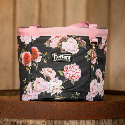 Rose Garden floral grooming tote shown on a wooden shelf, with pink handles and trim.