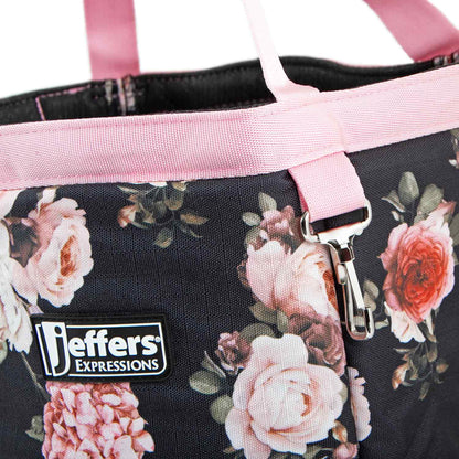 Close-up of the Rose Garden tote's pink rose print, pink trim, Jeffers patch, and metal clip.