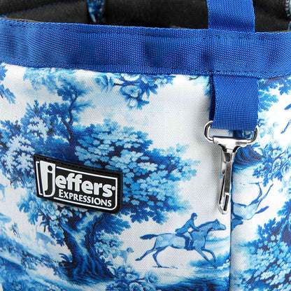 Close-up of the Equestrian Toile tote's blue-and-white horse print, blue trim, Jeffers patch, and metal clip.