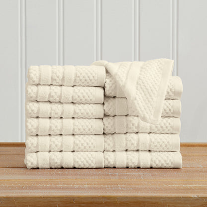 Ivory Giuliana Collection checkered jacquard washcloths folded and stacked.
