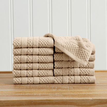 Sandstone Giuliana Collection checkered jacquard washcloths folded and stacked.
