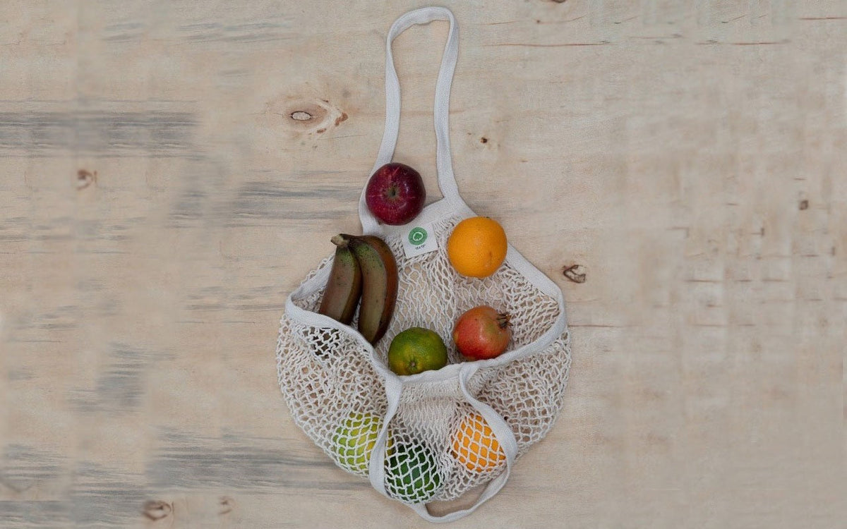 Cotton mesh bag laid flat with produce; contents not included
