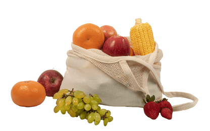 Cotton mesh tote holding fruit and corn; surrounding produce is not included.