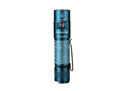 Graffiti-finish Fenix E35R flashlight shown upright with the side switch facing forward.