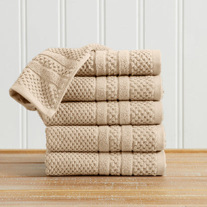 Sandstone Giuliana Collection checkered jacquard hand towels folded and stacked.