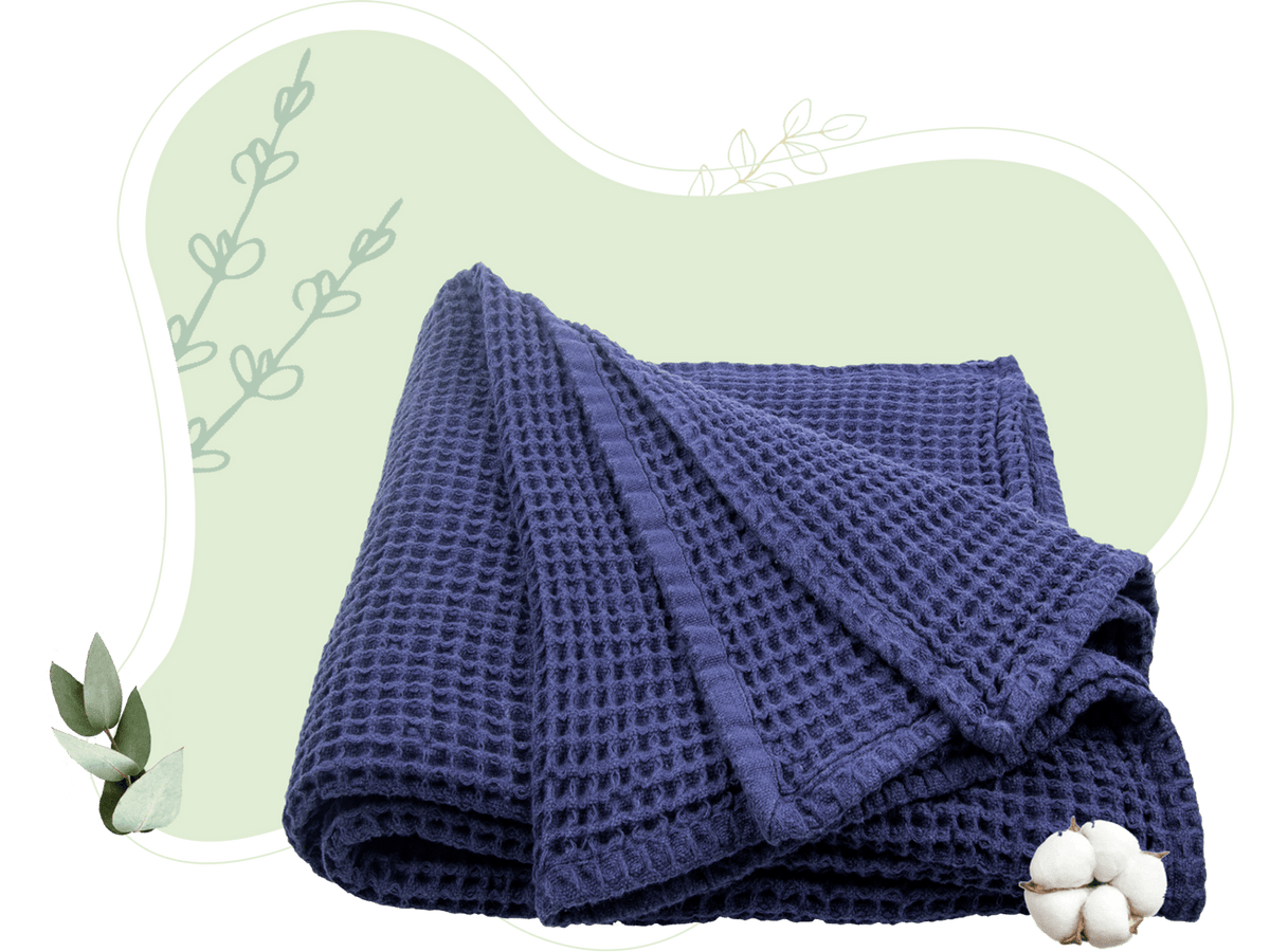 Blue cotton waffle weave throw draped to show its texture