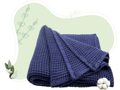 Blue cotton waffle weave throw draped to show its texture