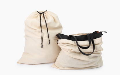 Natural cotton drawstring storage bags shown with a handbag.