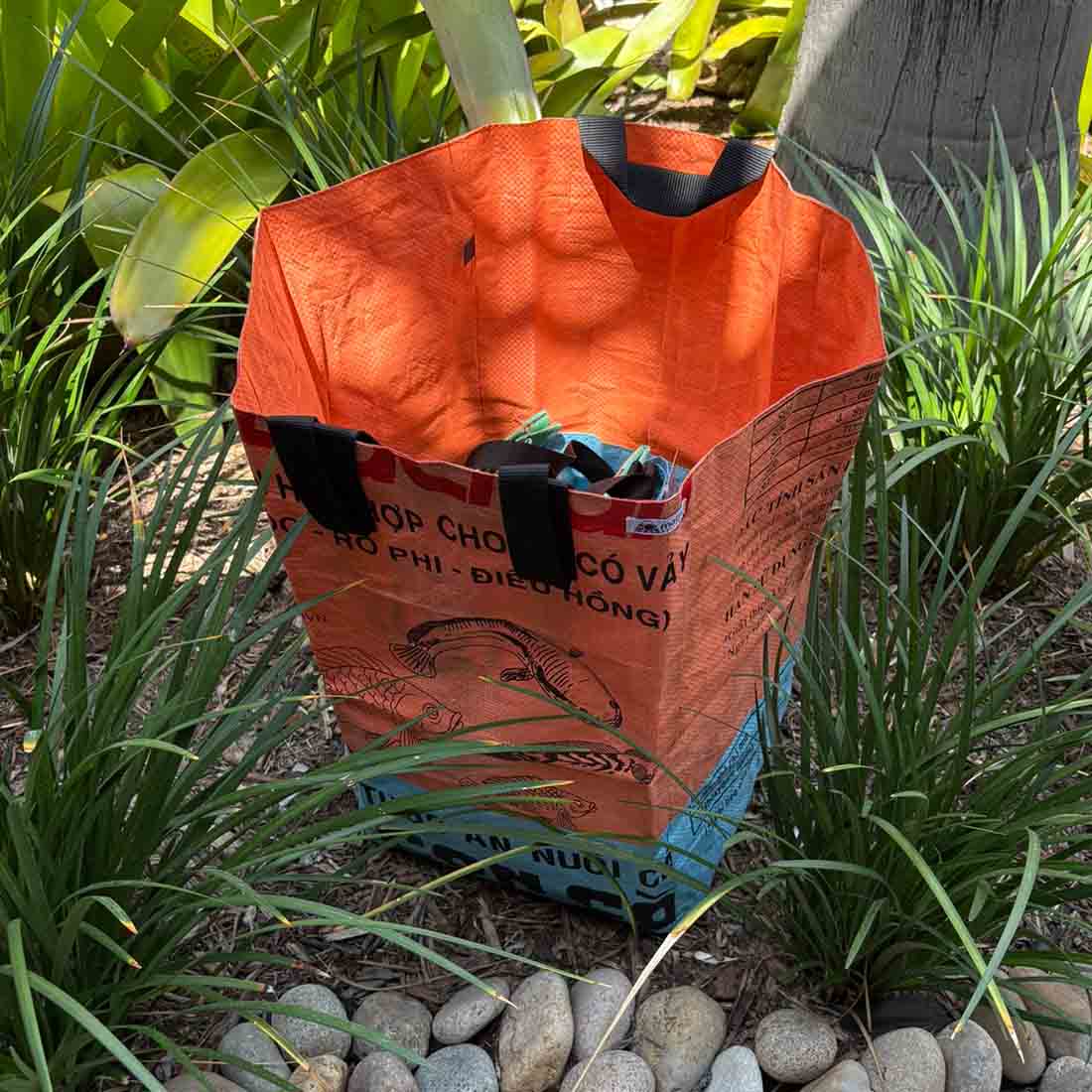 Open orange and light blue recycled laundry bin showing the interior.