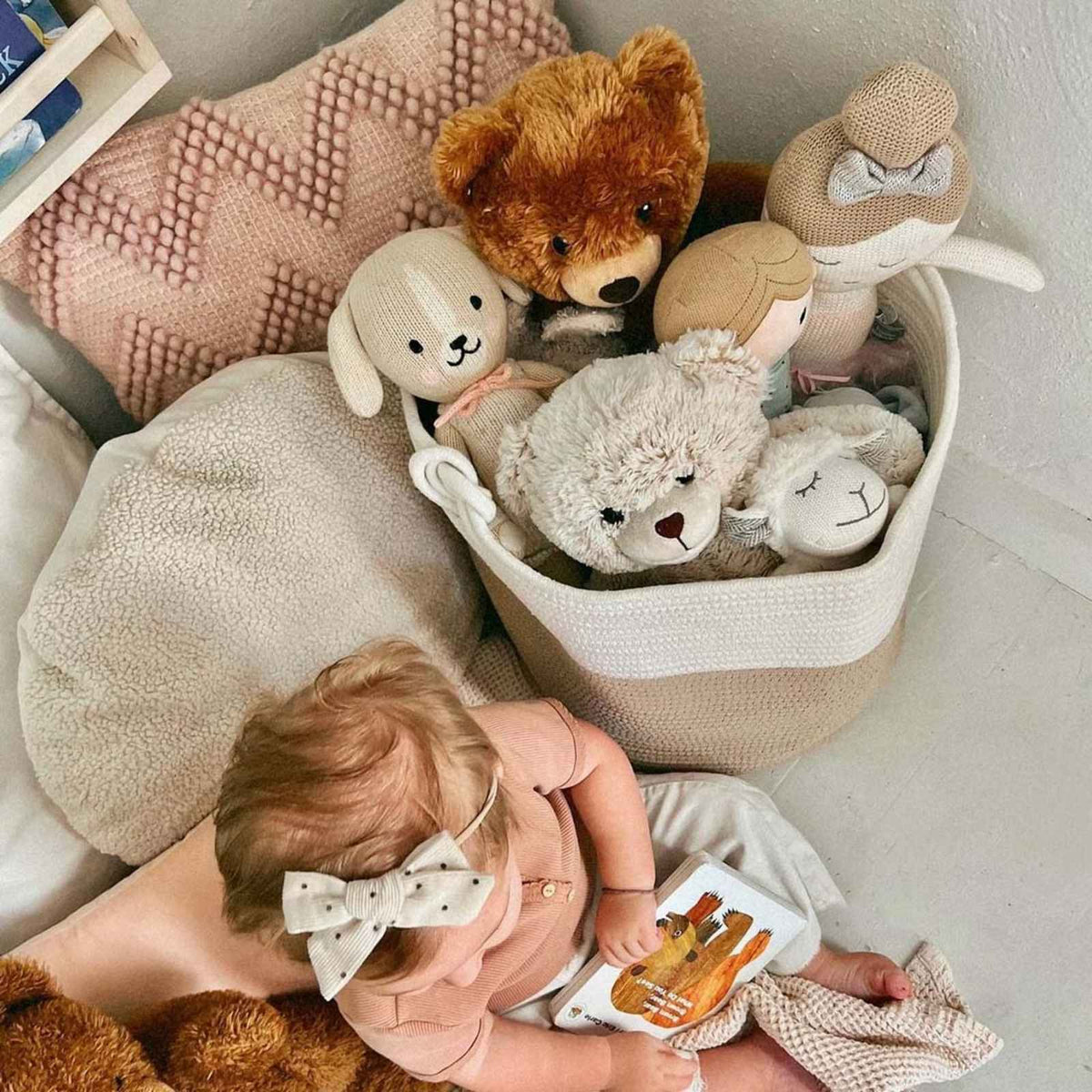 Overhead nursery view of the rope basket beside a baby; toys, bedding and other props are not included.