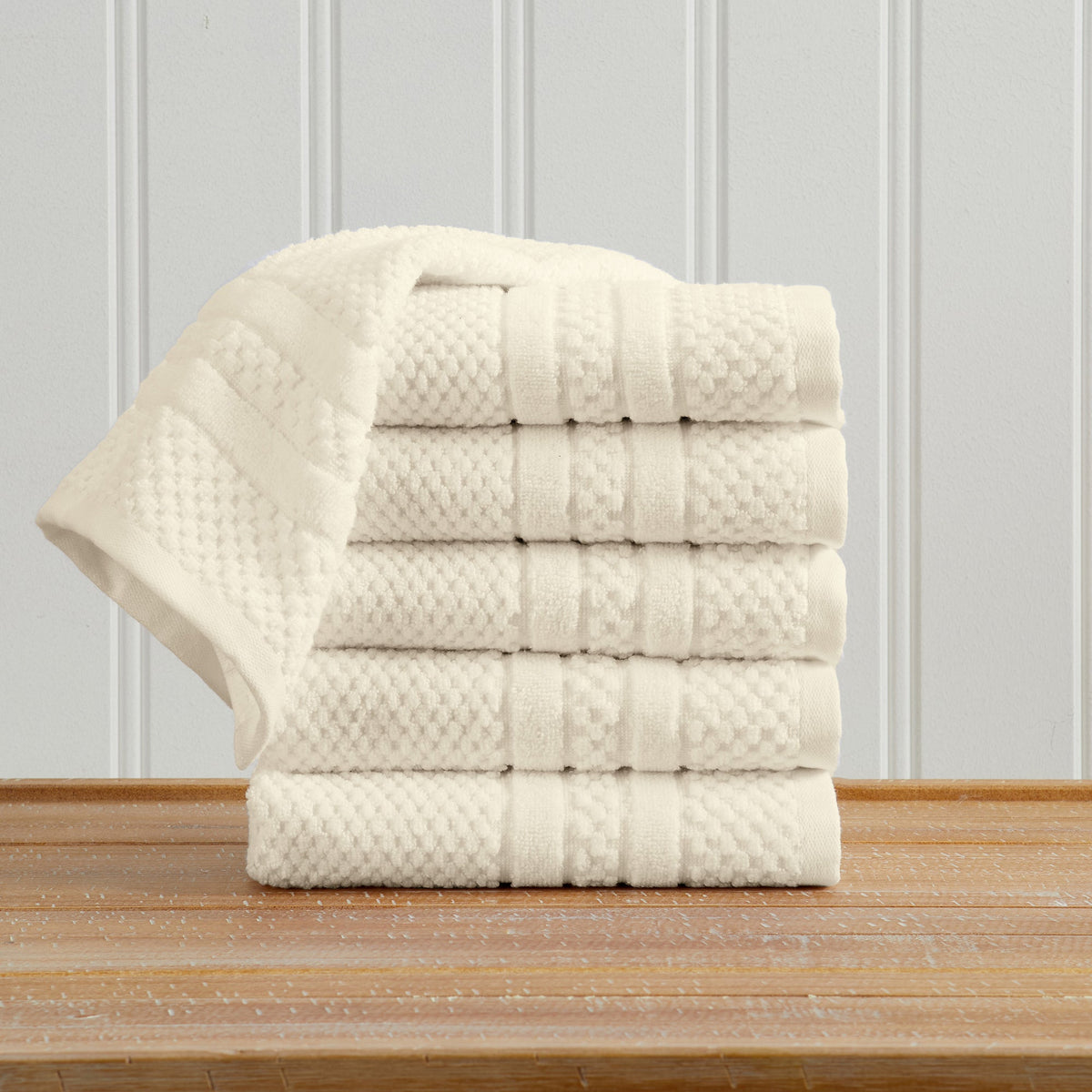 Ivory Giuliana Collection checkered jacquard hand towels folded and stacked.