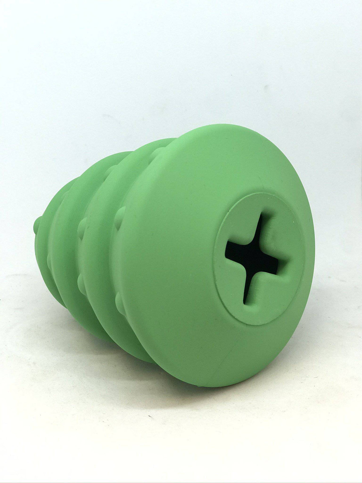 Cross-shaped opening on the base of the green Christmas Tree treat dispenser
