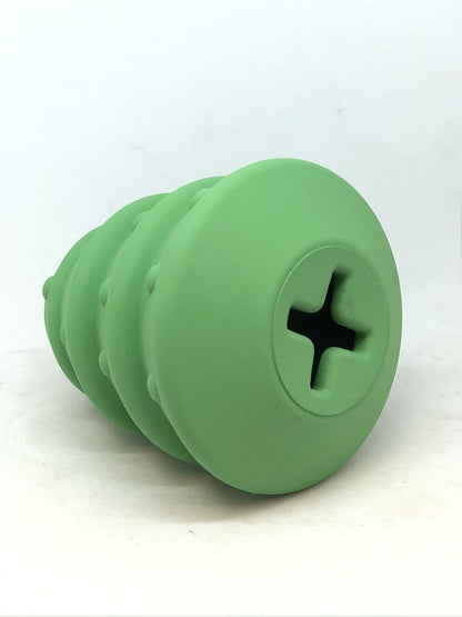 Cross-shaped opening on the base of the green Christmas Tree treat dispenser