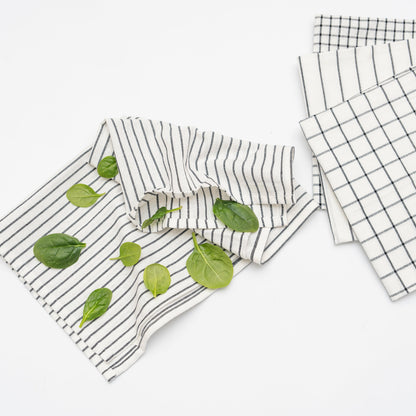 Black-and-white cotton kitchen towels shown with herbs; herbs not included
