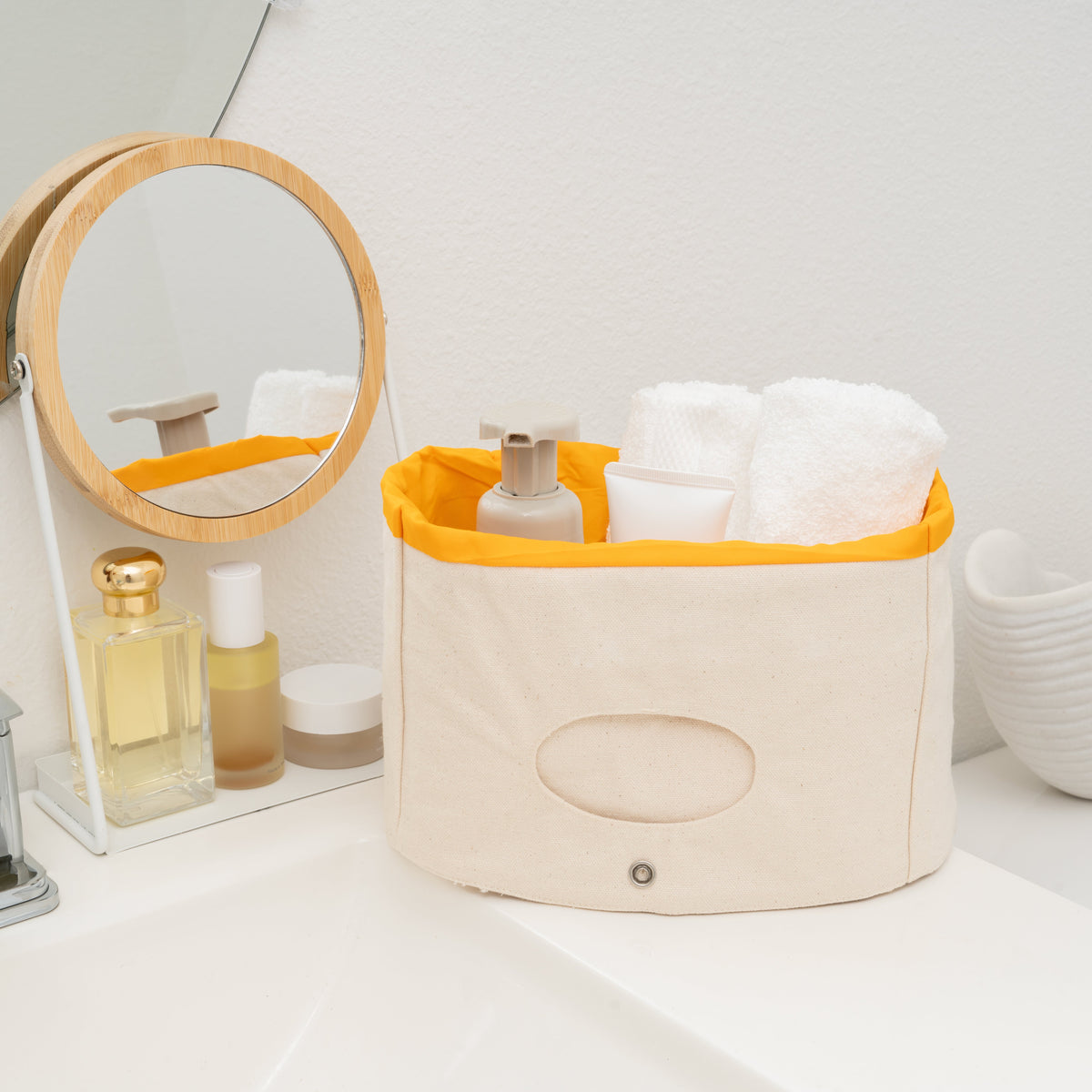 Canvas basket with yellow lining holding toiletries; accessories not included