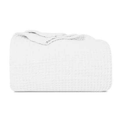 White cotton waffle weave throw folded on a white background