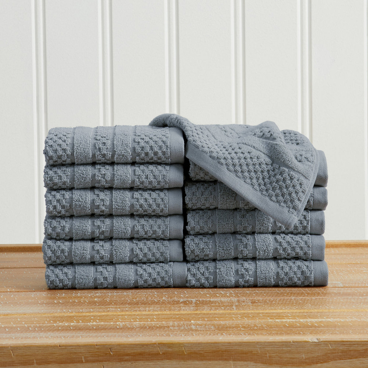 Blue Giuliana Collection checkered jacquard washcloths folded and stacked.
