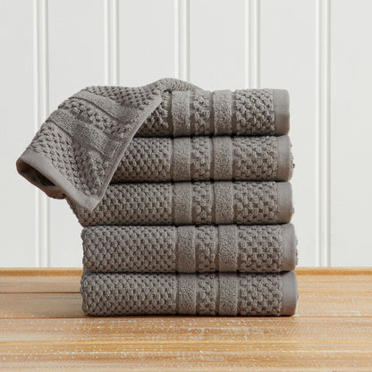 Dark Grey Giuliana Collection checkered jacquard hand towels folded and stacked.